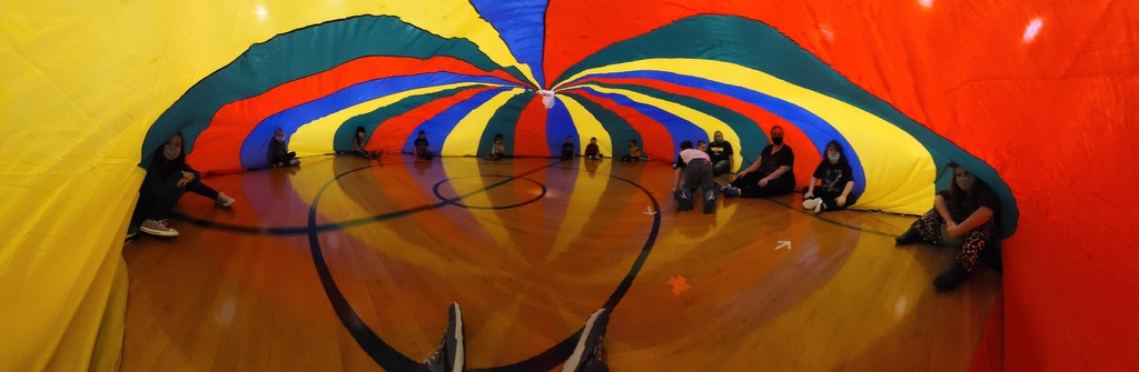 Kids under a parachute